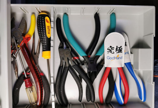Collection of scale modeling side cutters and pliers, highlighting the GodHand Ultimate Nipper with its protective white leather cover
