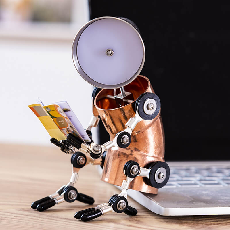 Humanoid cyberpunk desk lamp reading a book