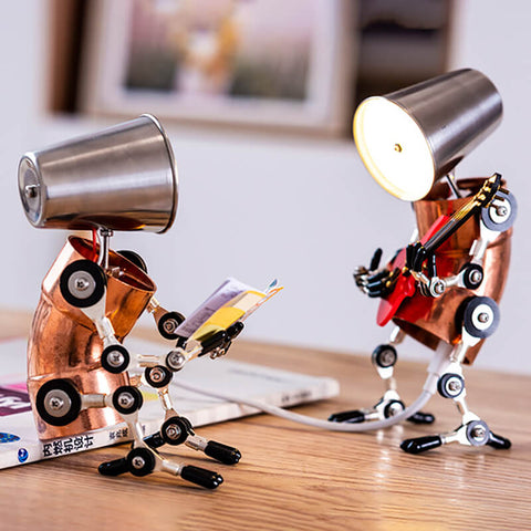 Two cyberpunk humanoid desk lamps placed on a desk