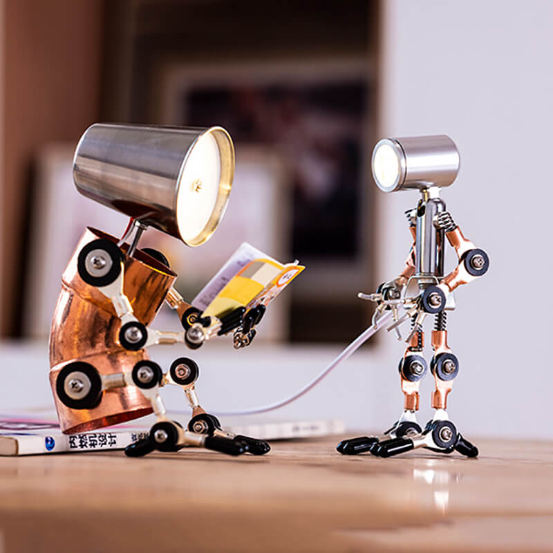 Two cyberpunk humanoid desk lamps placed on a desk