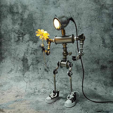 Humanoid desk lamp holding a flower