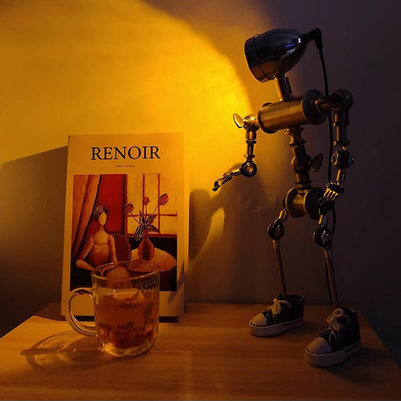 Humanoid desk lamp illuminating a magazine