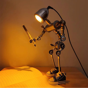 Humanoid desk lamp holding a pen