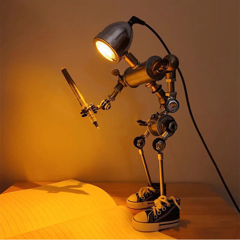 Humanoid desk lamp holding a pen