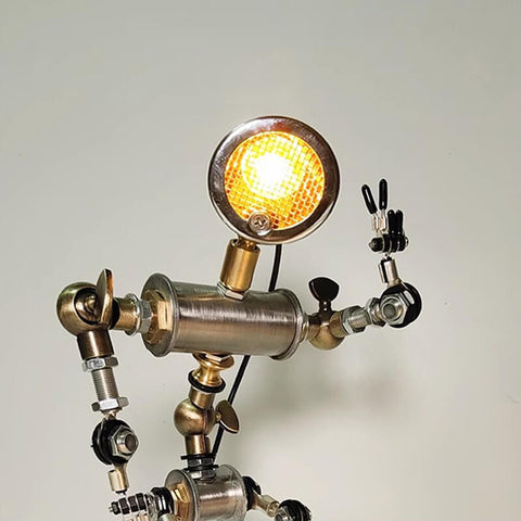 Humanoid desk lamp making a victory gesture